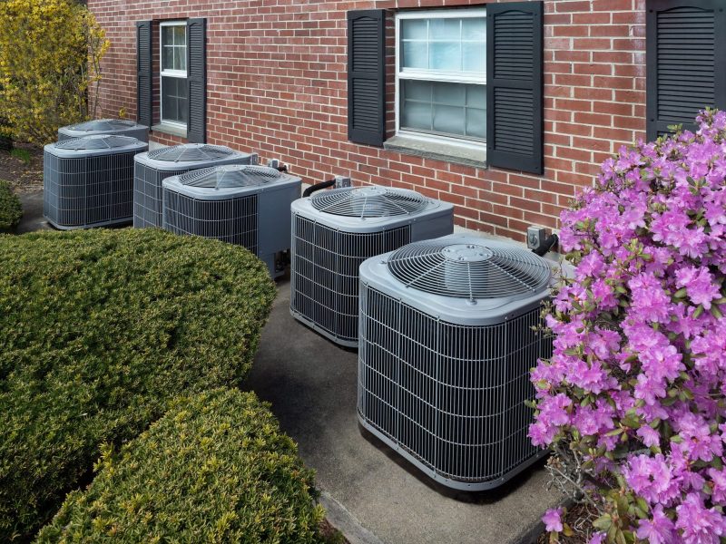 6 air conditioning units outside of apartment homes