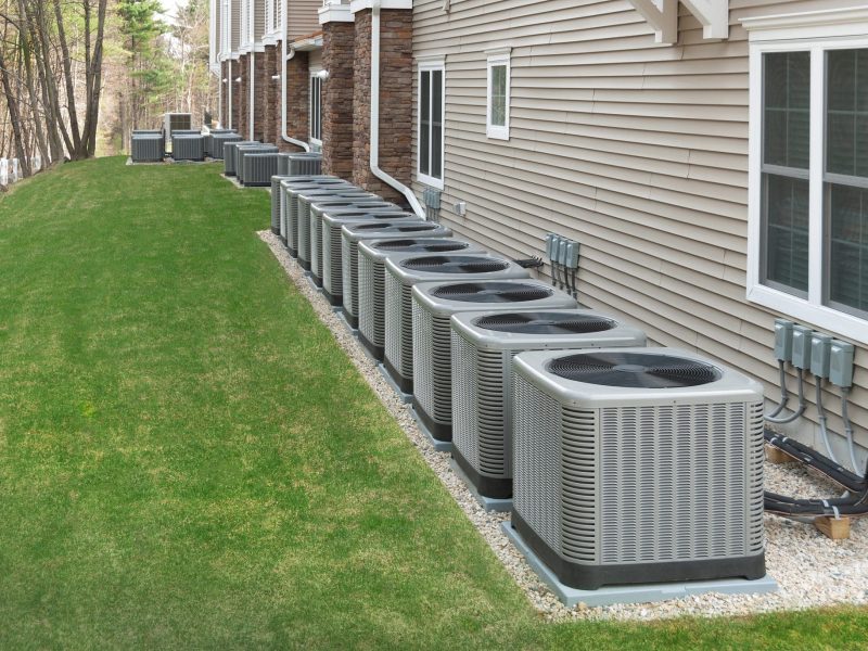 Multiple HVAC units outside of apartment homes