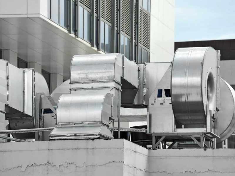 Industrial HVAC unit and vents on the rooftop of a commercial building