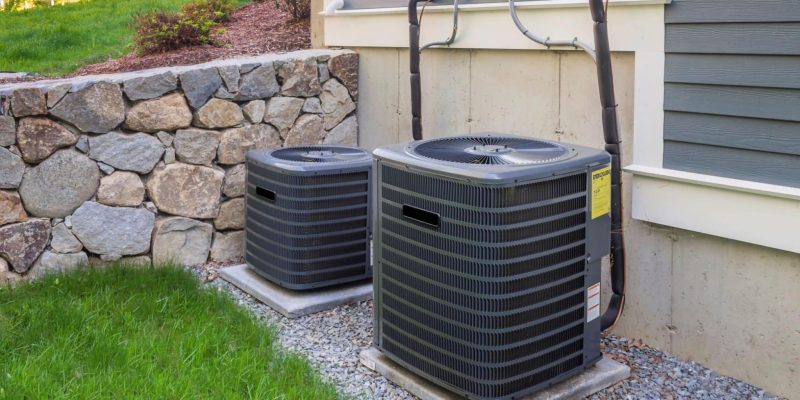 2 HVAC units installed outside of a home. One is larger than the other