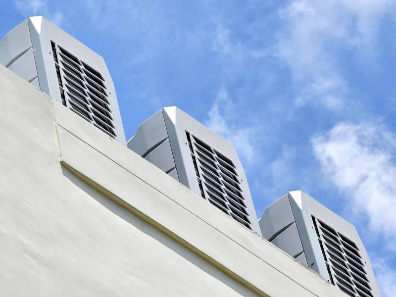 Vents of an HVAC unit on the top of a commercial building